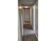 Hallway with neutral walls, multiple doors, and carpeted floor in a cozy residential home at 3305 Robinson St, Zellwood, FL 32798