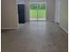 Open living room featuring sliding glass doors to the backyard and neutral color scheme at 3305 Robinson St, Zellwood, FL 32798