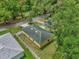 Aerial view showcases the house with a fenced yard, next to neighboring houses, and surrounded by lush trees at 339 Chinaberry Ave, Oviedo, FL 32765