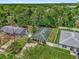 Aerial shot featuring a home with a well-manicured lawn and mature trees in a quiet neighborhood at 339 Chinaberry Ave, Oviedo, FL 32765