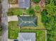Birds-eye view of a well-maintained house with a green roof, situated in a neatly landscaped neighborhood at 339 Chinaberry Ave, Oviedo, FL 32765