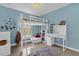 Stylish blue bedroom featuring a bunk bed, workspace, and coordinated decor providing a cozy retreat at 339 Chinaberry Ave, Oviedo, FL 32765