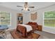 Bright bedroom showcasing natural light, a ceiling fan, and warm, inviting tones throughout the space at 339 Chinaberry Ave, Oviedo, FL 32765