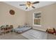 Cozy bedroom with a ceiling fan, ample natural light, and cheerful decorations, perfect for children at 339 Chinaberry Ave, Oviedo, FL 32765