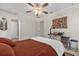 Well-lit bedroom with string lights, a ceiling fan, and neutral walls providing a cozy atmosphere at 339 Chinaberry Ave, Oviedo, FL 32765