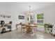 Bright dining room with a wooden table set, natural lighting, and neutral decor at 339 Chinaberry Ave, Oviedo, FL 32765