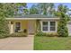 Charming single story home with a yellow exterior, lush greenery, and a welcoming front porch at 339 Chinaberry Ave, Oviedo, FL 32765