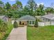 Charming home with a manicured lawn, a covered porch, and decorative shrubbery at 339 Chinaberry Ave, Oviedo, FL 32765