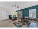 Bright living room features stylish furniture, a bookcase, and lots of natural light at 339 Chinaberry Ave, Oviedo, FL 32765
