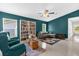 Cozy living room with beautiful tile flooring, comfortable seating, and a decorative book shelf at 339 Chinaberry Ave, Oviedo, FL 32765
