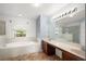 Bright bathroom featuring a soaking tub, double vanity with generous counter space, and a large mirror at 442 Churchill Ct, Kissimmee, FL 34759