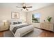 Inviting bedroom featuring a large bed, stylish decor, and a sunlit window view at 442 Churchill Ct, Kissimmee, FL 34759