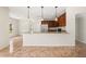 Open-concept kitchen featuring granite countertops, pendant lighting, and cherry wood cabinets at 442 Churchill Ct, Kissimmee, FL 34759