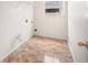Clean laundry room with tile floors, open shelves, and a bright window at 442 Churchill Ct, Kissimmee, FL 34759