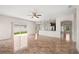 Bright living area with tile flooring flowing into an open kitchen, enhanced by natural light from sliding glass doors at 442 Churchill Ct, Kissimmee, FL 34759
