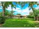 A spacious backyard features lush green grass, mature trees, and a charming white picket fence at 4739 Indian Gap Dr, Orlando, FL 32812