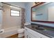 Charming bathroom featuring a tub, a vanity with granite counters and a unique mirror at 4739 Indian Gap Dr, Orlando, FL 32812