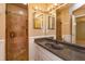 Bathroom featuring stone shower, a vanity with granite countertop, and decorative lighting at 4739 Indian Gap Dr, Orlando, FL 32812