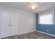 Bedroom with wood floors, ceiling fan, and blue accent wall at 4739 Indian Gap Dr, Orlando, FL 32812