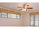 Bedroom featuring large windows with decorative fabric valances and a ceiling fan at 4739 Indian Gap Dr, Orlando, FL 32812