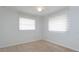 Cozy bedroom with carpet, ceiling fan, and natural light from two windows at 4739 Indian Gap Dr, Orlando, FL 32812