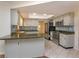 Kitchen with white cabinets, stainless steel appliances, green countertops and decorative backsplash at 4739 Indian Gap Dr, Orlando, FL 32812