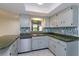 Kitchen with white cabinets, stainless steel dishwasher, countertops, and geometric tile floors at 4739 Indian Gap Dr, Orlando, FL 32812