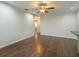 Open living room with hardwood floors, white walls, and a ceiling fan at 4739 Indian Gap Dr, Orlando, FL 32812