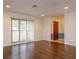 Bright room with wood floors, white walls, a large window, and a solid wood door at 4739 Indian Gap Dr, Orlando, FL 32812