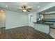 Inviting living room with hardwood floors, white walls, ceiling fan and pass-through to the kitchen at 4739 Indian Gap Dr, Orlando, FL 32812