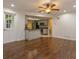 Living room with hardwood floors, open to kitchen, and with door to the outside at 4739 Indian Gap Dr, Orlando, FL 32812