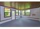 Bright sunroom with wood paneled ceiling, tile floors and many windows at 4739 Indian Gap Dr, Orlando, FL 32812