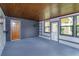 Spacious sunroom with wood ceiling, blue tile floor, and multiple windows at 4739 Indian Gap Dr, Orlando, FL 32812