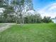 Large backyard with fresh green grass and trees, offering privacy at 527 Rio Grande Dr, Poinciana, FL 34759