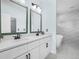 Bathroom featuring double sinks with quartz countertops, textured accent wall, modern fixtures, and tiled floor at 527 Rio Grande Dr, Poinciana, FL 34759