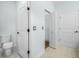 Bright bathroom featuring hexagon floor tiles, new toilet, and fresh paint at 527 Rio Grande Dr, Poinciana, FL 34759