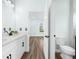 Bathroom featuring double sink, quartz countertops, toilet, and view into next room at 527 Rio Grande Dr, Poinciana, FL 34759