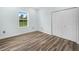 Bright bedroom with wood-look floors, double door closet and a sunny window at 527 Rio Grande Dr, Poinciana, FL 34759