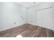 Minimalist bedroom with plank floors and spacious closet at 527 Rio Grande Dr, Poinciana, FL 34759