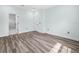 Bright bedroom with wood-look floors, ample natural light, and a doorway leading to an en-suite bathroom at 527 Rio Grande Dr, Poinciana, FL 34759