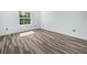 Light-filled bedroom with wood-look flooring and a large window, offering a serene and inviting space at 527 Rio Grande Dr, Poinciana, FL 34759