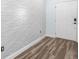 Modern entryway showcasing decorative wall tiles and wood-look flooring at 527 Rio Grande Dr, Poinciana, FL 34759