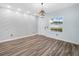 Bright entryway featuring decorative wall tile, wood-look flooring, and modern light fixture at 527 Rio Grande Dr, Poinciana, FL 34759