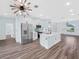 Bright kitchen with stainless steel appliances, island with sink, and white cabinetry at 527 Rio Grande Dr, Poinciana, FL 34759