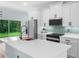 Bright kitchen featuring white cabinets, stainless steel appliances, island with quartz countertops, and outdoor view at 527 Rio Grande Dr, Poinciana, FL 34759