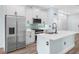 Modern kitchen featuring stainless steel appliances, island, and white cabinets at 527 Rio Grande Dr, Poinciana, FL 34759