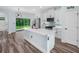 Kitchen boasts a large island, stainless appliances, white cabinetry, modern lighting, and an adjacent pantry at 527 Rio Grande Dr, Poinciana, FL 34759