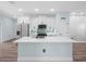 Modern kitchen with an island, stainless steel appliances, and white cabinets at 527 Rio Grande Dr, Poinciana, FL 34759