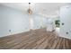 Open-concept living space with wood-look floors, modern lighting, and access to the kitchen at 527 Rio Grande Dr, Poinciana, FL 34759