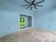 The covered patio features a fan, pavers and sliding glass doors at 527 Rio Grande Dr, Poinciana, FL 34759